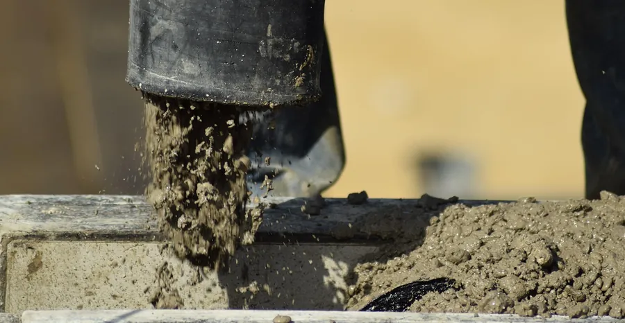 Concrete pump hose pouring wet concrete into a form, Bartlesville